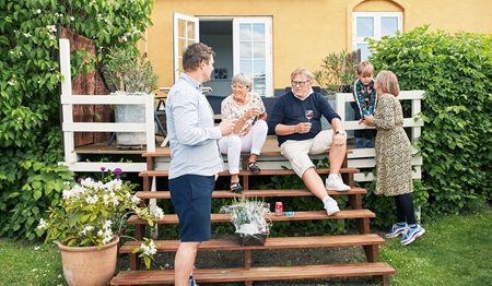 Family sitting outside on stairs in garden