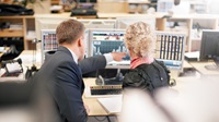 collegues looking at stock rate