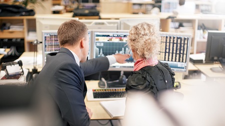 collegues looking at stock rate