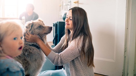 Teenage girl cuddling dog